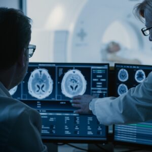 AdobeStock_236237515_In Control Room Doctor and Radiologist Discuss Diagnosis while W