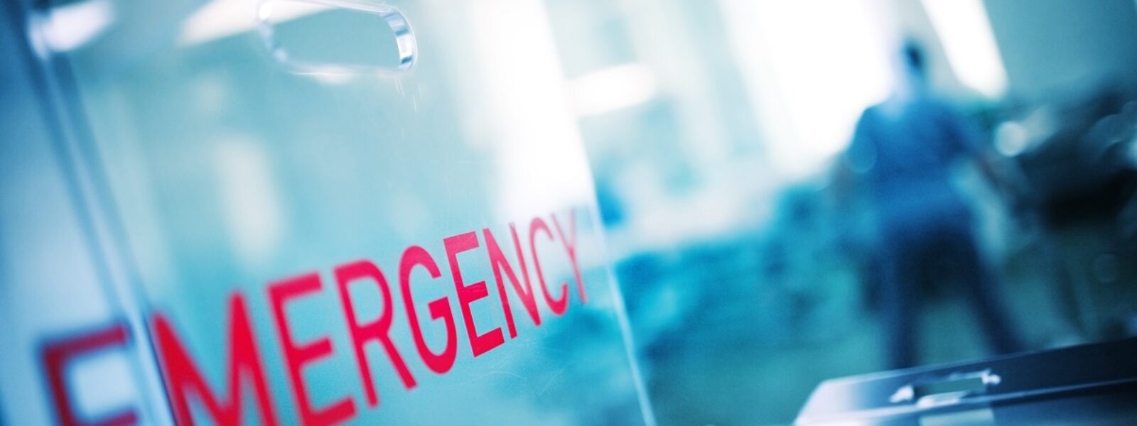 AdobeStock_399635850_The inscription "urgency" on the plastic glass against the backg